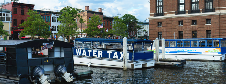 Scene of Baltimore City harbor in Fells Point with rowhomes where we restore hardwood floors to original look