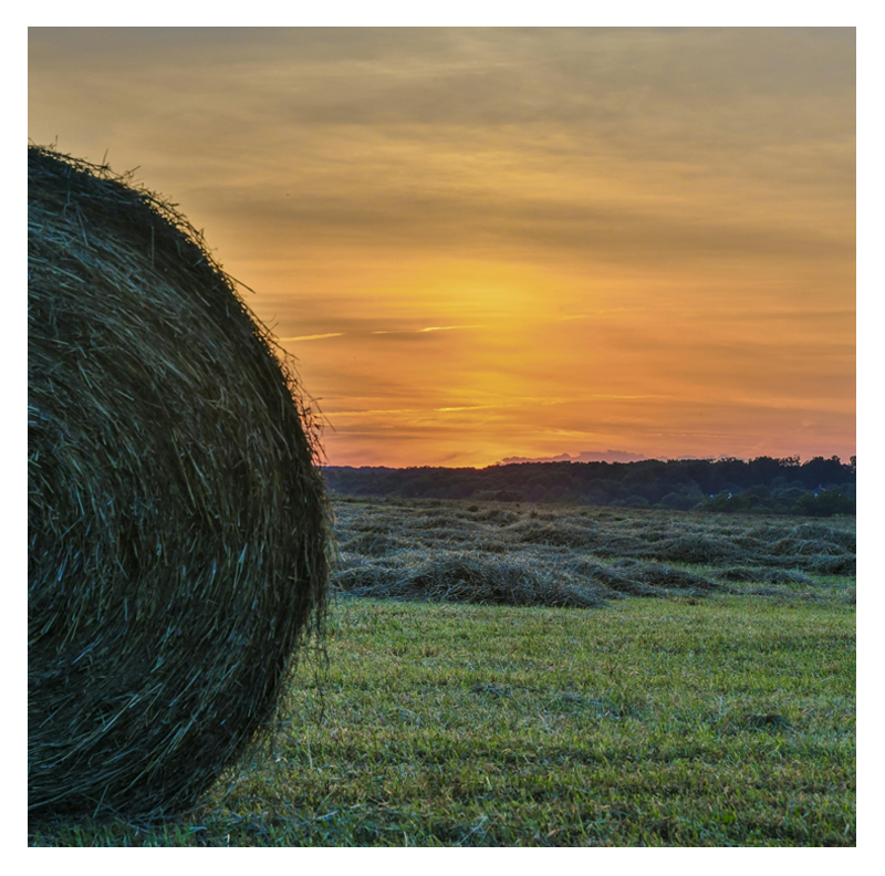 Hay with a sunset in a Harford County Maryland scene with small mountains near where we do floor installations